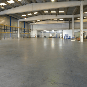 Large warehouse space with sleek, polished concrete floors maintained by polished concrete professionals team