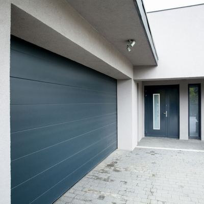 Contemporary house exterior featuring a sleek dark garage door and matching front entrance door design