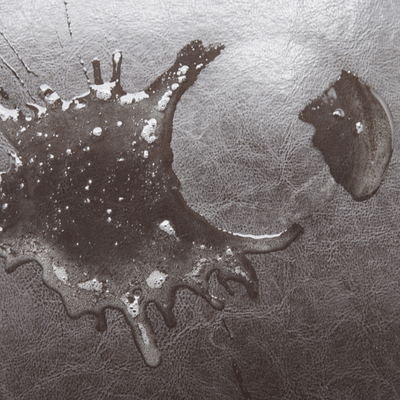 Close view of person power-washing stained concrete slab, blasting dirt away for cleaner, safer surfaces
