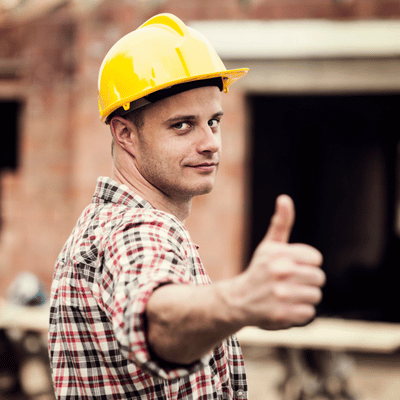 Construction worker in yellow hardhat giving thumbs-up, satisfied customer after concrete removal austin tx service
