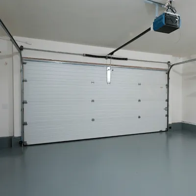 Freshly coated garage floor with white door, highlighting durable garage flooring austin finish options